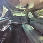 Lincoln 8 passenger limo in the daylight showing the black interior leather seat as it sits outside a wedding venue in Austin Texas