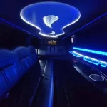 Lux Line Transportation's white lincoln limousines that hold up to 8 passengers with it's blue LEDs lit up in the interior and has black leather seating and a bar